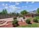 This home's outdoor space boasts a custom fire pit, flagstone, and lush landscaping at 5441 Lynx St, Frederick, CO 80504