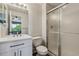 Bathroom with a modern white vanity, frosted glass shower, and updated fixtures at 5441 Lynx St, Frederick, CO 80504
