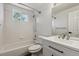 Bright, updated bathroom featuring white tiling and modern fixtures at 5441 Lynx St, Frederick, CO 80504