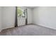 Bright bedroom featuring neutral gray walls, gray carpeting, and a window at 5441 Lynx St, Frederick, CO 80504
