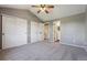 Bedroom with ample closet space, vaulted ceiling, view of bath, and modern ceiling fan at 5441 Lynx St, Frederick, CO 80504