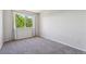 Bright bedroom featuring a large window with natural light and neutral gray carpeting at 5441 Lynx St, Frederick, CO 80504