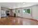 Modern kitchen with stainless steel appliances, neutral cabinets, hardwood floors, and large windows for plenty of light at 5441 Lynx St, Frederick, CO 80504