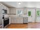 Modern kitchen featuring stainless steel appliances, neutral cabinets, countertop, and hardwood floors at 5441 Lynx St, Frederick, CO 80504