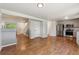 Open concept kitchen with stainless steel appliances, neutral cabinets, hardwood floors, and access to living room at 5441 Lynx St, Frederick, CO 80504
