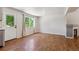 Bright living room featuring hardwood floors, fireplace, and large windows allowing ample natural light at 5441 Lynx St, Frederick, CO 80504