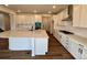 The open kitchen offers ample counter space, a large island, and stainless steel appliances at 283 Wooten Ave, Brighton, CO 80601