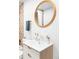 Bathroom vanity with round mirror, white sink, and modern fixtures provides a sleek design at 2313 S Race St # A, Denver, CO 80210