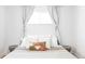 Bright bedroom with modern decor: decorative pillow, side tables, and draped curtains at 2313 S Race St # A, Denver, CO 80210
