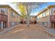 Exterior view of multi-unit buildings with symmetrical entrances and autumn foliage at 2313 S Race St # A, Denver, CO 80210