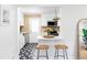 Modern kitchen features updated appliances, black and white patterned floors, and an eat-in counter at 2313 S Race St # A, Denver, CO 80210