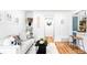 Charming living room featuring stylish white couch, decorative pillows, and hardwood floors leading to the dining area at 2313 S Race St # A, Denver, CO 80210