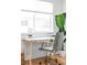 Close up of a bright office area with a modern desk, comfortable chair, and natural light at 2313 S Race St # A, Denver, CO 80210