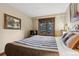 Cozy bedroom with king bed, wood accents, and scenic window view at 50 Mountain Thunder Dr # 1212, Breckenridge, CO 80424