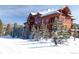 Exterior view featuring a multi-story building with balconies and a skier on the slopes at 50 Mountain Thunder Dr # 1212, Breckenridge, CO 80424