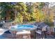 Outdoor hot tub surrounded by stone and lush greenery, perfect for relaxation at 50 Mountain Thunder Dr # 1212, Breckenridge, CO 80424