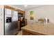 Functional kitchen with stainless steel refrigerator, electric range, ample counter space and knotty pine cabinets at 50 Mountain Thunder Dr # 1212, Breckenridge, CO 80424