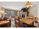 Inviting living room with stone fireplace and views of snow-covered trees at 50 Mountain Thunder Dr # 1212, Breckenridge, CO 80424