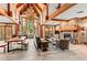 Spacious lounge area with a stone fireplace, wood beams, and comfortable furniture at 50 Mountain Thunder Dr # 1212, Breckenridge, CO 80424