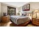 Comfortable main bedroom with king bed, wood furnishings, and a picturesque view at 50 Mountain Thunder Dr # 1212, Breckenridge, CO 80424