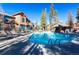 Sparkling outdoor pool with lounge chairs, tables, and surrounding greenery at 50 Mountain Thunder Dr # 1212, Breckenridge, CO 80424