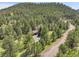 Secluded mountain home surrounded by a dense forest, offering privacy and tranquility at 150 Soda Creek Rd, Evergreen, CO 80439