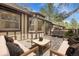 Relax on this back deck featuring outdoor furniture and a dining table with seating at 150 Soda Creek Rd, Evergreen, CO 80439