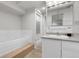 Bright bathroom featuring a shower and a vanity with a white vessel sink at 150 Soda Creek Rd, Evergreen, CO 80439