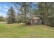 Inviting two-story home featuring a stone foundation and lush green lawn at 150 Soda Creek Rd, Evergreen, CO 80439