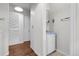 Hallway features a bathroom with blue sink, storage, and access to wood floor room at 150 Soda Creek Rd, Evergreen, CO 80439