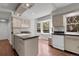 Well-lit kitchen showcasing an island cooktop, modern appliances, ample cabinet space, and large windows at 150 Soda Creek Rd, Evergreen, CO 80439