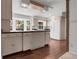 Bright kitchen features an island, wood floors, light-colored cabinets, and large windows offering natural light at 150 Soda Creek Rd, Evergreen, CO 80439