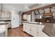 Spacious kitchen with stainless steel appliances, an island cooktop, and a brick wall fireplace in the background at 150 Soda Creek Rd, Evergreen, CO 80439