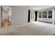 A large living room with a big window, neutral walls, and light colored carpet flooring at 150 Soda Creek Rd, Evergreen, CO 80439