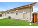 Back exterior with lawn, siding, and access door at 405 Cypress St, Broomfield, CO 80020