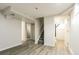 Finished basement with wood-look floors, stairs, and a bathroom entrance at 405 Cypress St, Broomfield, CO 80020