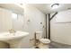 Functional bathroom with a pedestal sink, toilet, and exposed piping at 405 Cypress St, Broomfield, CO 80020
