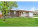 Single-story home with a well-maintained lawn and landscaping at 405 Cypress St, Broomfield, CO 80020