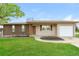 Charming single-story home featuring a brick facade and attached garage at 405 Cypress St, Broomfield, CO 80020