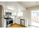 Bright kitchen with stainless steel appliances and a view to the backyard at 405 Cypress St, Broomfield, CO 80020
