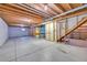 Unfinished basement featuring wood beams and concrete flooring at 19155 E Kansas Dr, Aurora, CO 80017
