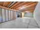 Open basement with bare concrete floor and wooden beams on the ceiling at 19155 E Kansas Dr, Aurora, CO 80017