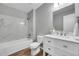 White tiled bathroom with new bathtub and vanity with a marble countertop at 19155 E Kansas Dr, Aurora, CO 80017