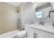 Bathroom with tile shower, modern vanity with marble countertop, updated fixtures, and a framed mirror at 19155 E Kansas Dr, Aurora, CO 80017