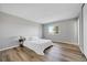 Cozy bedroom showcasing hardwood floors, a queen bed, a window with natural light, and neutral paint at 19155 E Kansas Dr, Aurora, CO 80017