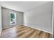 Simple bedroom featuring a window, hardwood floors, grey walls and neutral colors at 19155 E Kansas Dr, Aurora, CO 80017