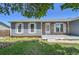 The exterior of this cozy home is framed by mature trees, enhancing its curb appeal and creating a welcoming atmosphere at 19155 E Kansas Dr, Aurora, CO 80017