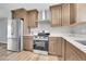 Modern kitchen boasts stainless steel appliances, granite countertops, and ample storage at 19155 E Kansas Dr, Aurora, CO 80017