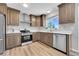 Bright kitchen featuring stainless steel appliances, granite countertops, and ample cabinet space at 19155 E Kansas Dr, Aurora, CO 80017