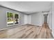 Sunlit living area features wood floors, light walls, and multiple entryways, creating a modern space at 19155 E Kansas Dr, Aurora, CO 80017
